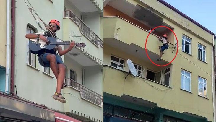 Öğrenci evine şarkıyla veda etti! Eşyaların taşındığı halatın üzerinde gitar şov yaptı